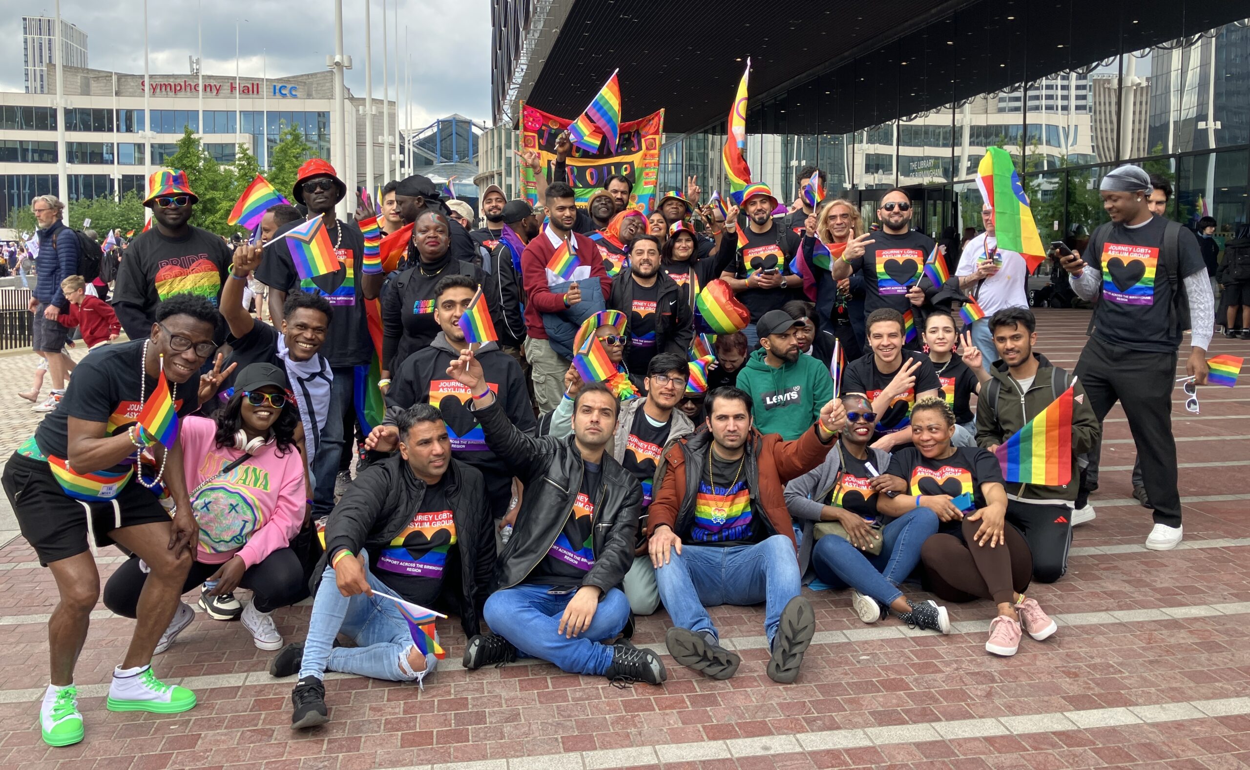 A large group of Journey members in colourful clothes